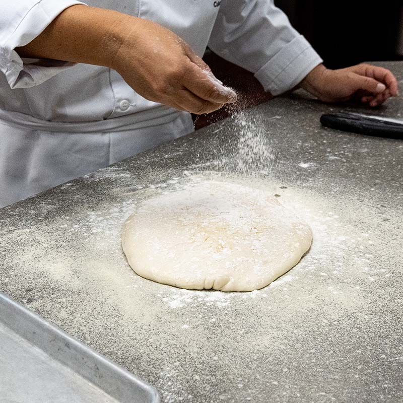 cheff prepping pizza dough